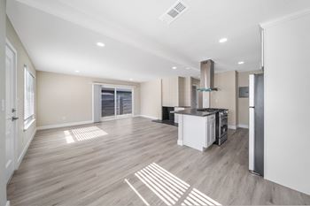 a renovated living room and kitchen in a new home